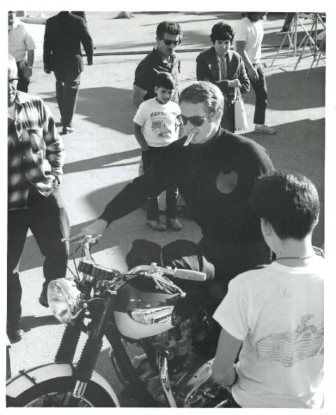 Steve riding a motorbike on set.